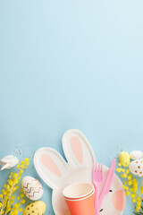 Easter joy unveiled: delights in kids' egg-citement. Top view vertical photo of bunny shaped plate, eggs, cups, cutlery, mimosa, sprinkles on pastel blue background with space for congratulations