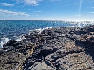 Walking the Arrecife, Lanzarote seaside promenade offers a blend of coastal charm and Canarian architecture.