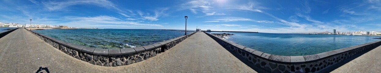 Walking the Arrecife, Lanzarote seaside promenade offers a blend of coastal charm and Canarian...
