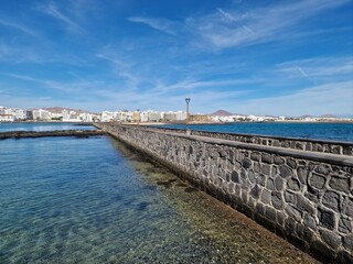 Walking the Arrecife, Lanzarote seaside promenade offers a blend of coastal charm and Canarian architecture.