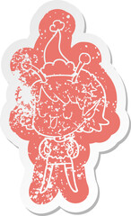 happy alien girl cartoon distressed sticker of a wearing santa hat