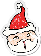 distressed sticker cartoon of a male face with beard wearing santa hat