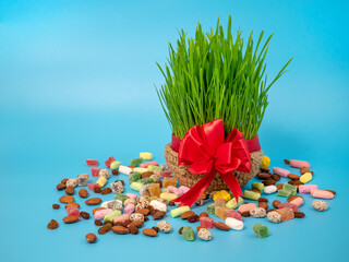 Green wheat sprouts and sweets for the Navruz holiday. The traditional celebration of the vernal...