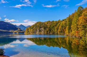 The Alpsee is a lake in the Ostallgäu district of Bavaria, Germany, located southeast of Füssen. It is close to the Neuschwanstein and Hohenschwangau castles.  - Powered by Adobe