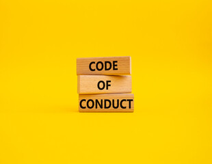 Code of conduct symbol. Wooden blocks with words Code of conduct. Beautiful yellow background. Business and Code of conduct concept. Copy space.