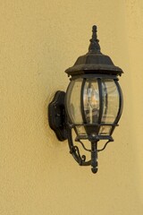 Carriage lantern mounted to stucco wall