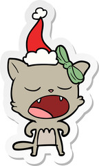 sticker cartoon of a cat meowing wearing santa hat