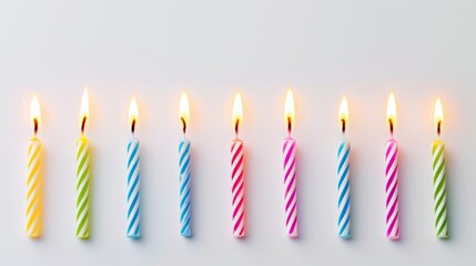 Row of Lit Birthday Candles in Different Colors
