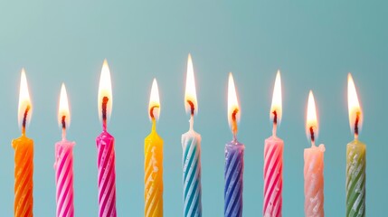 Row of Lit Birthday Candles in Different Colors