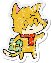 distressed sticker of a cartoon happy fox with gift