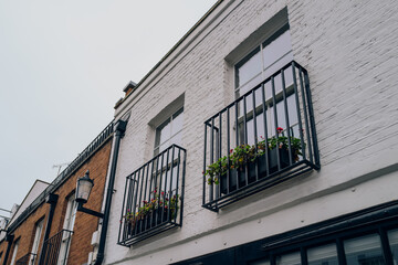 Obraz premium Low angle view of Juliet balconies on a mews house in London, UK.