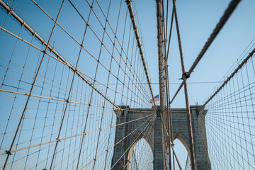 View of Brooklyn Bridge in New York City, USA, on a sunny winter day against blue sky.