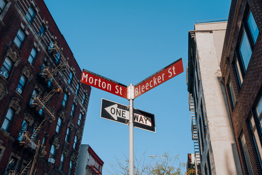 Street name signs on the corners of Morton and Bleecker streets in New York City, USA.