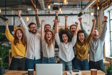 Diverse business team employees celebrating good news with their fists up in the air. Business win, corporate success
