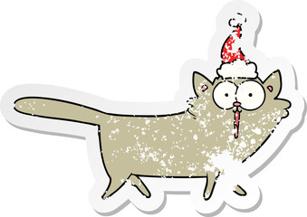 distressed sticker cartoon of a cat wearing santa hat