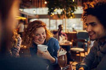 Young diverse group of people having coffee in a cafe