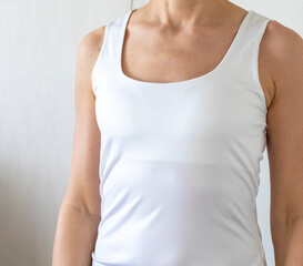 Shot of the woman in the white top against the white wall. Concept