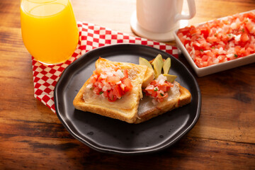 Breakfast toast with refried beans, avocado, melted cheese and mexican pico de gallo sauce. Easy and healthy homemade recipe that can be made in the oven, frying pan or air fryer.