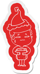 cartoon  sticker of a anxious boy carrying book wearing santa hat