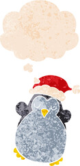 cute christmas penguin and thought bubble in retro textured style