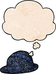 cartoon bowler hat and thought bubble in grunge texture pattern style