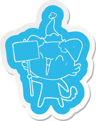 happy little cartoon  sticker of a dog holding sign wearing santa hat