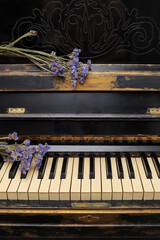 composition of purple flowers statice or limonium sinuatum on an old shabby piano. holiday card with copy space