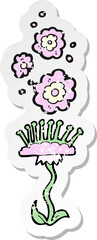 retro distressed sticker of a cartoon perfumed flower
