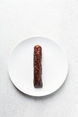 Top view of chinese sausage in a white plate, overhead view of lap cheong sausage on white background