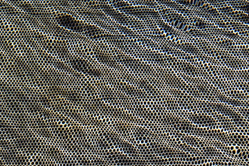Perforated metal surface underwater texture background
