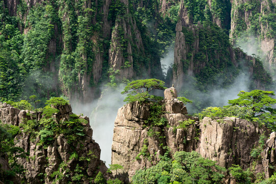 Clouds float amidst the Second Ring Road in the West Sea (Xihai) Grand Canyon of Huangshan Yellow Mountains.