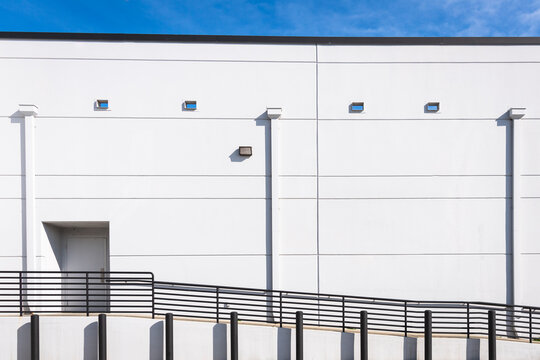 White Building Wall. Ramp and Railing