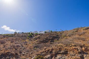 Stunning view of mountain landscape of Gran Canaria island with hotels perched atop the hills. Spain.