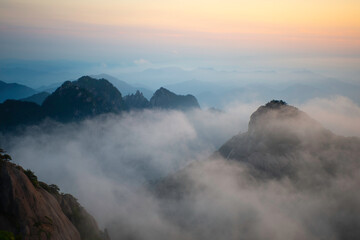 Clouds sink heavily amongst the mountains in the White Cloud Scenic Area in Huangshan Yellow Mountains.