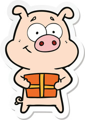 sticker of a happy cartoon pig holding christmas present