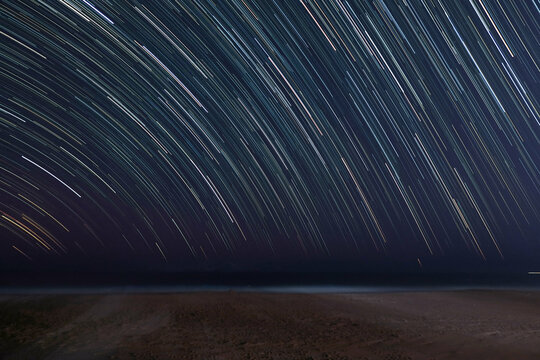 Star trail on beach background with space for text