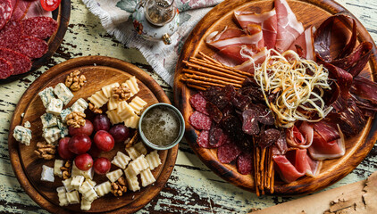 Snacks and Wine appetizer sets, cold meat plates with sausage, ham, salami, prosciutto, bacon and...