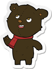 sticker of a cartoon black bear wearing scarf