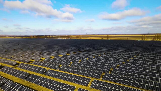 Aerial view of a large power plant with many rows of solar photovoltaic panels to produce clean electricity. Renewable electricity with zero emissions