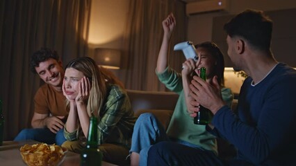 Excited gamers rejoicing video game victory at home evening gathering close up. 