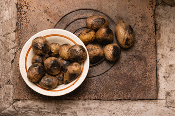 Unpeeled potatoes baked in a rustic oven