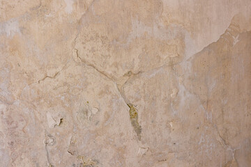 Old plastered wall with a crack. Concrete wall background.