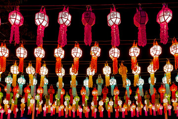 Fototapeta na wymiar Lights and Lanterns concept, Celebrated annually Loy Krathong, Multi colourful of lamps illuminated in the night, Traditional handicraft of Northern Thailand during the Yi Peng festival in November.