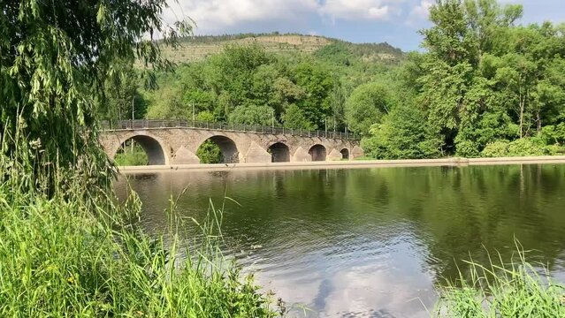 Saale river with historical bridge in Jena Burgau