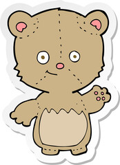 sticker of a cartoon little teddy bear waving