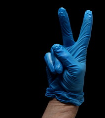 Blue surgical gloves on hand isolated on black, clipping 
