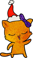 textured cartoon of a cat with bow on head wearing santa hat