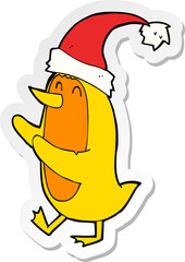 sticker of a cartoon bird wearing xmas hat