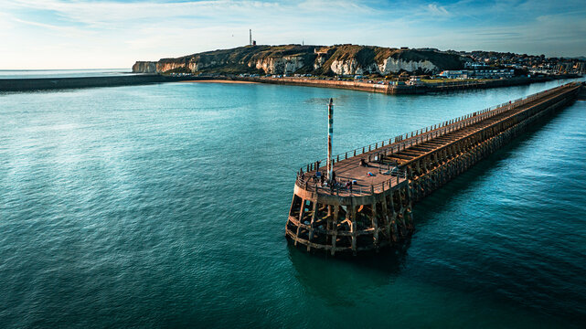 Fototapeta Aerial view of Newhaven Pier in blue waters, East Sussex, UK