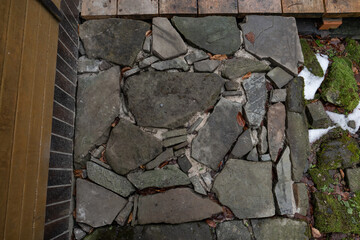 Stones set in concrete as a sidewalk.
